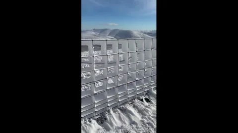 UK: Rime ice forms striking patterns on snow fence in Skiddaw, England, U... Stock Footage 329110387