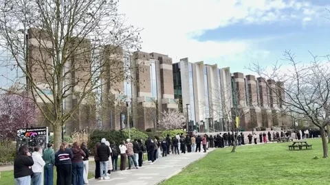 UK: Students queue for antibiotics at the University of Kent as two peopl... Stock Footage 330864323
