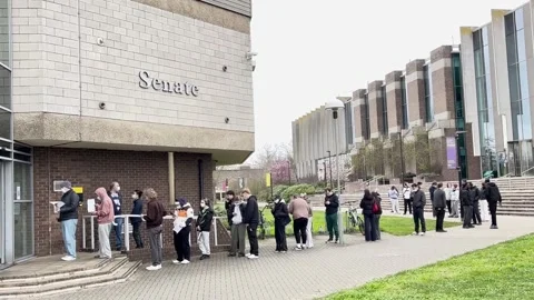 UK: Students queue for antibiotics at the University of Kent after mening... Stock Footage 330942527