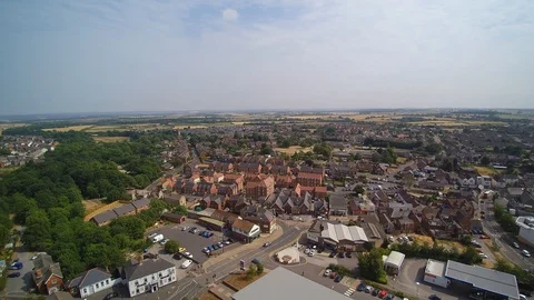 UK Town centre aerial shot showing houses, roads, cars, trucks, buildings Stock Footage