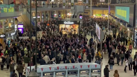 UK: Train services disrupted at Waterloo Station after Clapham Junction i... Stock Footage 320749858
