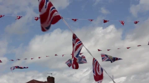 UK Union Jack flag bunting on summer sky during a street party 스톡 동영상 47486722