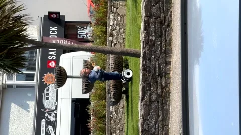 UK: Warwick Davis rides segway while eating ice cream in Perranporth, Eng... 스톡 동영상 335353672