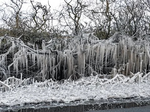 UK weather with icicles formed from splashed road water Photos