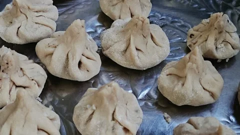 Ukdiche modak hand-shaped dumplings arranged on a traditional silver platter bef Stock Footage 345505959