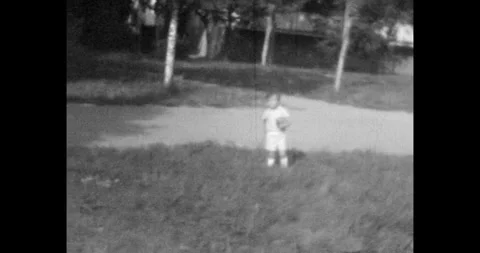 Ukraine - circa 1970s: Retro soviet footage, a young boy holding a ball Stock Footage 337161854