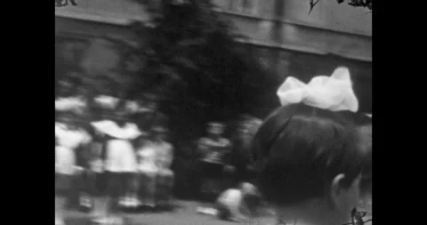 Ukraine - circa 1970s: Young Soviet schoolgirl ringing the traditional bell Stock Footage 339653738