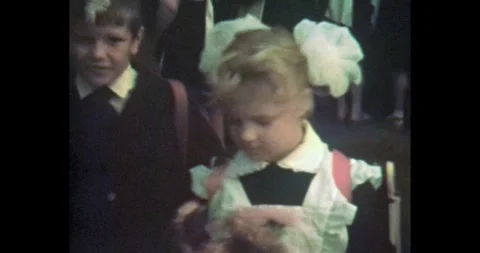 Ukraine - circa 1980s: First Grader Girl with Flowers on September 1 Stock Footage 323655548