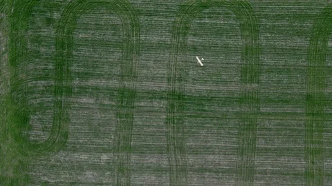 Ukraine Circa spring 2023 -A drone an airplane is flying over green fields Video stock 240176686