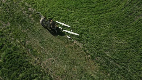 Ukraine Circa spring 2023 - Three soldiers are preparing to launch drones in a Stock Footage 240086033