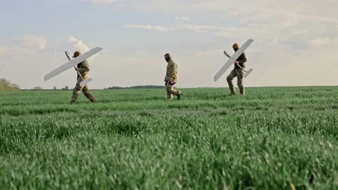 Ukraine Circa spring 2023 - Three soldiers are preparing to launch drones in a Stock Footage 240086719
