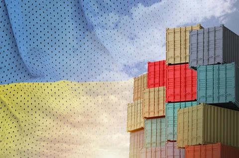 Ukraine flag and big stack of shipping cargo containers in docks with sky Foto stock