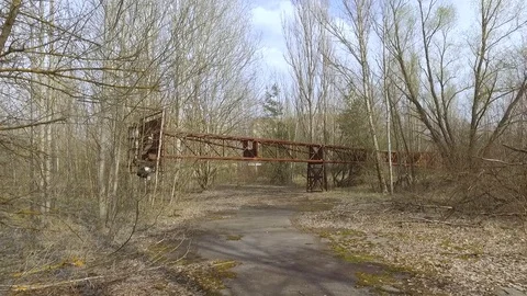 Ukraine, Pripyat: Fallen support for searchlights at the stadium Stock Footage 74521189