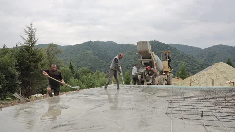 Ukraine Vorochta 10.09.2026 Five construction workers pour and level a Stock Footage 346769267