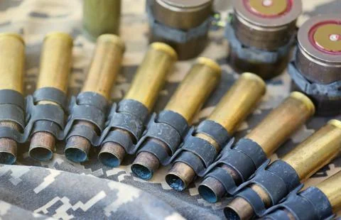 Ukrainian army fabric and machine gun belt shells lies on ukrainian pixeled Stock Photos