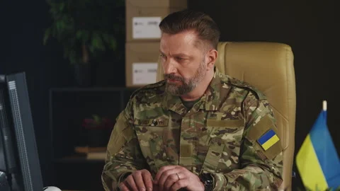 Ukrainian army officer typing on computer, planning special operations Stock Footage 335537729