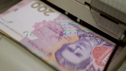 Ukrainian banknotes in currency counting machine recounts cash hryvnias money UA Stock Footage 160276841