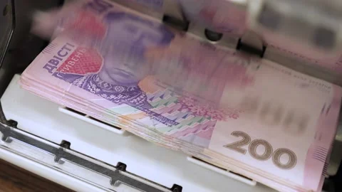 Ukrainian banknotes in currency counting machine recounts cash hryvnias money UA Stock Footage 160276981
