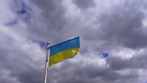 Ukrainian banner wave on the background of cloudy, dramatic sky. Video stock 183304372