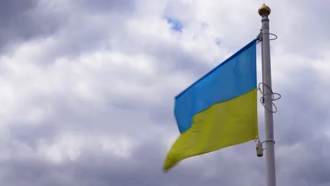 Ukrainian banner wave on the background of cloudy, dramatic sky. Video stock 183304531