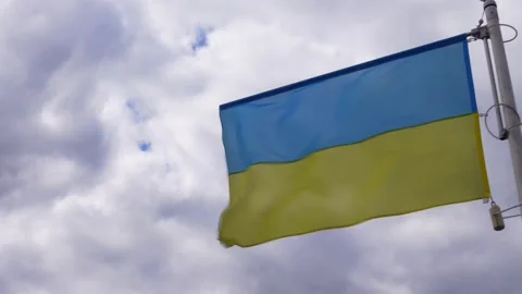 Ukrainian banner wave on the background of cloudy, dramatic sky. Video stock 183304760