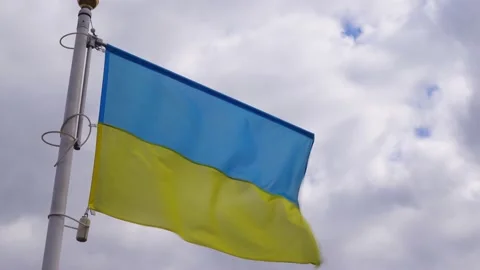 Ukrainian banner wave on the background of cloudy, dramatic sky. Video stock 183304820