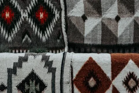Ukrainian blankets with unique geometric patterns in various shades. Stock Photos