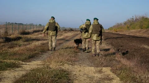 Ukrainian border guards march along the state border of Ukraine with weapons and Stock Footage 205847985