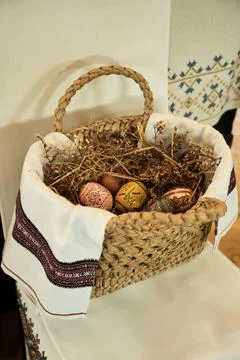 Ukrainian Easter eggs in a rustic straw filled Easter basket. Egg decorating Stock Photos