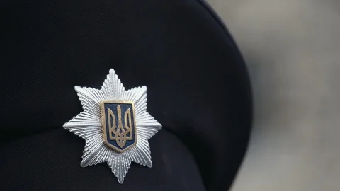 Ukrainian emblem on the hat of policeman Stock Footage 107337764