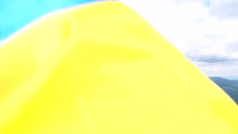 Ukrainian flag close up on the wind mountains on background Video stock 211385295