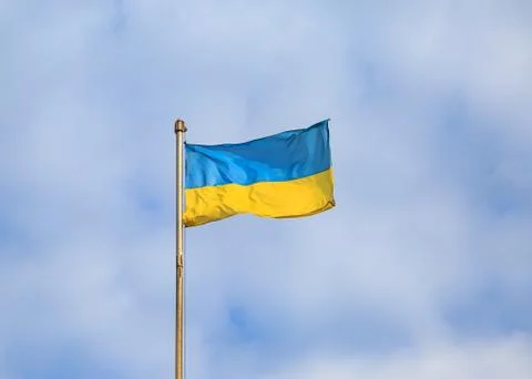 Ukrainian flag with cloudy sky background Stock Photos