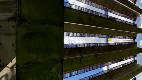 The Ukrainian flag develops in the wind on a concrete structure against a blue 動画素材 201534271