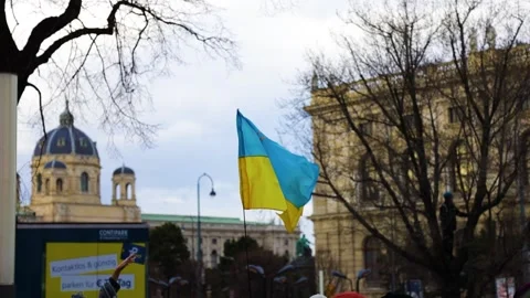 An Ukrainian flag moving in the wind at a protest in Vienna, Austria Stock Footage 171126946