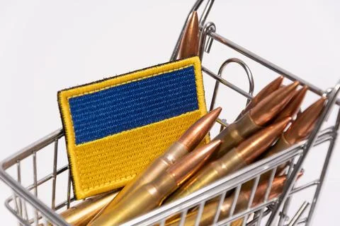 Ukrainian flag patch and rifle cartridges inside miniature shopping cart Stock-Fotos