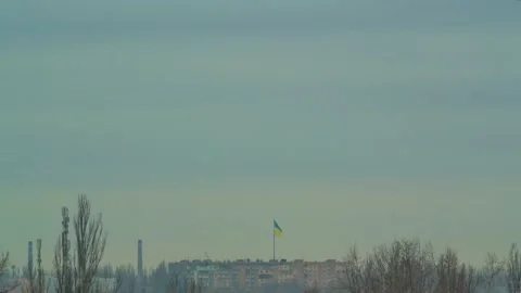 Ukrainian flag wave in the wind flagpole national symbol above city time lapse Stock Footage 234002535
