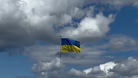 Ukrainian flag waving on flagpole with  blue sky and white clouds at background Stock Footage 201423720