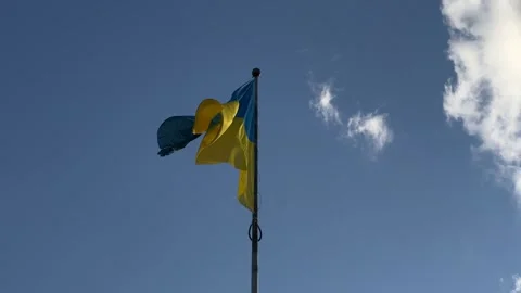 Ukrainian flag waving on the wind with blue sky with clouds at background Stock Footage 246973030