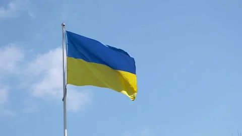 Ukrainian flag on a wind on a blue cloudy sky background at sunny day. Stock Footage 139647621