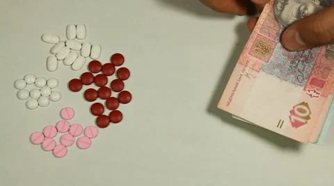 Ukrainian Hryvna UAH, Counting Drugs and Money, Health Care, Colorful Pills Stock Footage