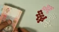 Ukrainian Hryvna UAH, Counting Drugs and Money, Health Care, Colorful Pills HD Footage