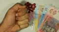 Ukrainian Hryvna UAH, Counting Drugs and Money, Health Care, Colorful Pills HD Footage