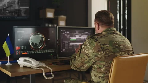 Ukrainian intelligence officer uploading gathered data, conducting surveillance Stock Footage 333307423