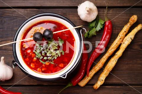 Ukrainian meat soup solyanka in metal bowl Stock Photos