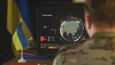Ukrainian officer analyzing satellite data for threat assessment, surveillance Stock Footage 335537891