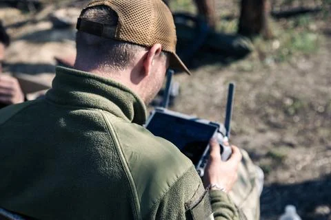 Ukrainian operator holding drone controller with screen outdoors Stock Photos