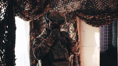 A Ukrainian pilot in full gear and body armor, with an FPV strike drone Stock Footage 343507728