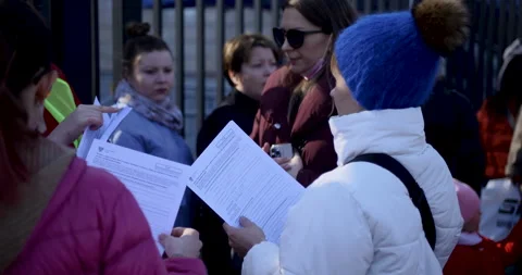 Ukrainian refugees hold the forms at the registration center at the Stock Footage 199236874