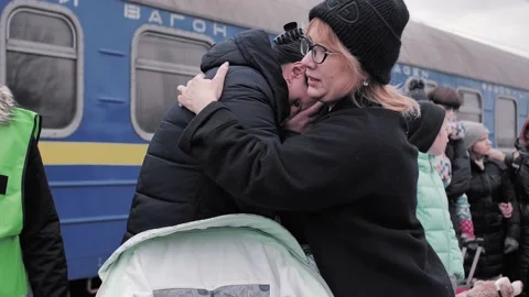 Ukrainian refugees. A woman is crying and hugging other women on the Stock Footage