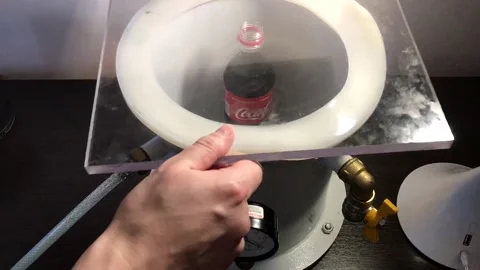 Ukrainian scientist makes bottle of Coca-Cola bubble over using vacuum Stock Footage 273016483